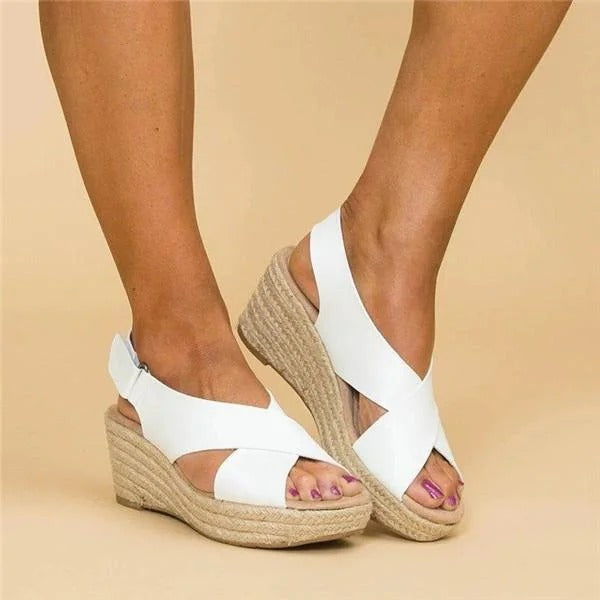 Women's white Aeris wedge platform sandals with crossover straps and espadrille sole.