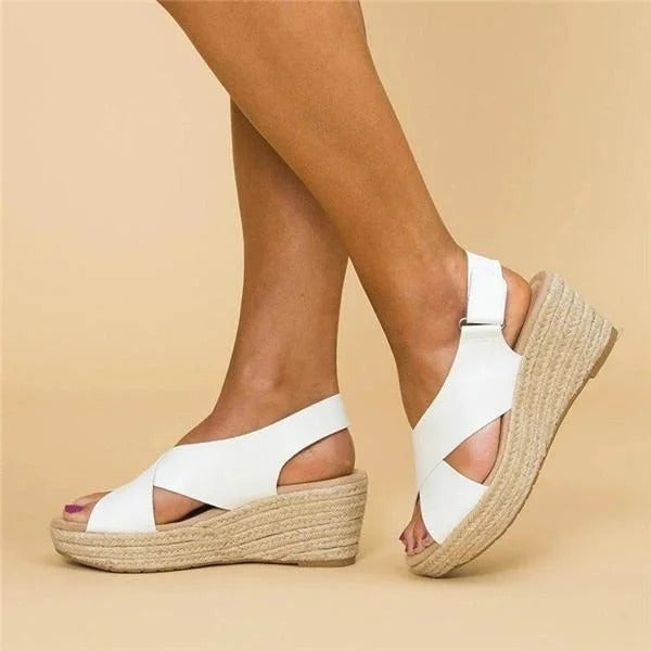 Women's white Aeris wedge platform sandals with crossover straps and espadrille sole.