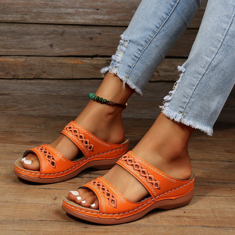 Alice women's orange double strap slide sandals with decorative cutout detailing, worn with jeans.