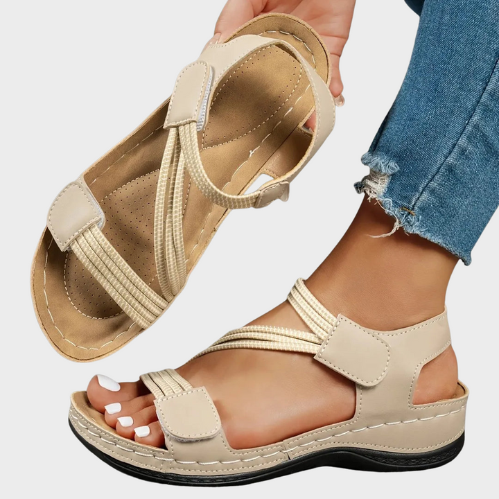 Amalyn women's beige adjustable strap flat sandals with contrast stitching, perfect for warm-weather outfits.