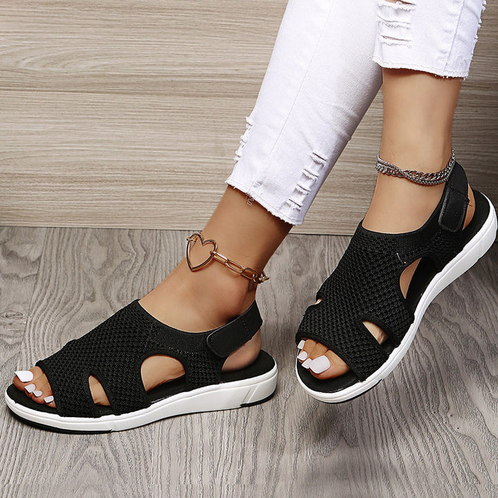 Amiel black open-toe slingback sport sandals with a soft knit-style upper and sporty flat sole for easy comfort.