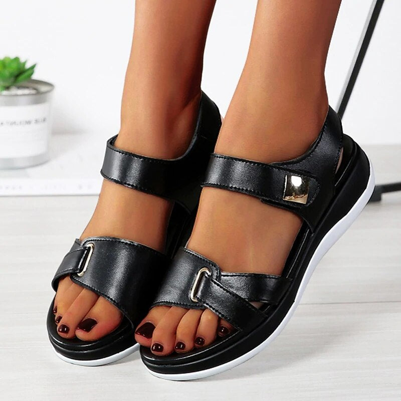 Chanda women's black open-toe back strap sandals with buckle details and a low platform sole.
