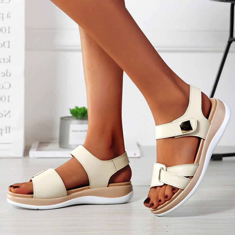 Chanda women's open-toe back strap sandals in cream with wide front straps, buckle details, and a low platform sole.
