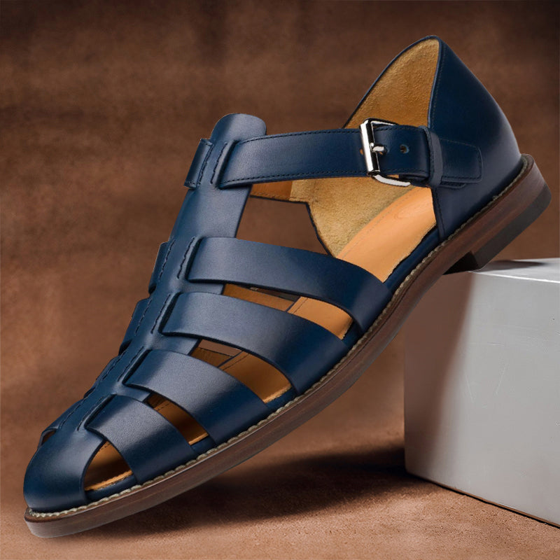 Clara navy vegan leather fisherman sandals with woven closed-toe design and adjustable buckle strap for polished summer style.