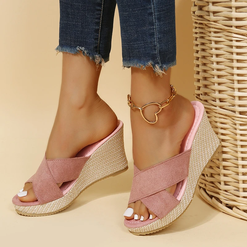 Women's pink suede Cora wedge slide sandals with crossed straps and a textured sole for easy summer style.
