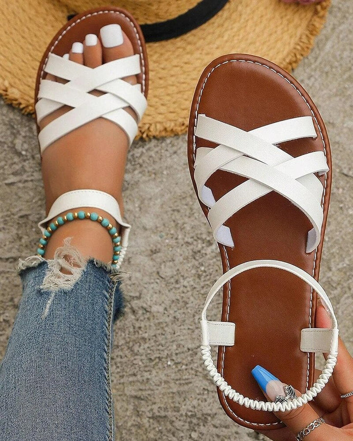 White Corinne flat sandals with woven-look cross straps and a flexible back strap for effortless summer styling.