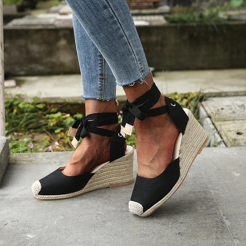 Black Elowen lace-up wedge espadrille sandals with closed toe, natural jute sole, and ankle ties.