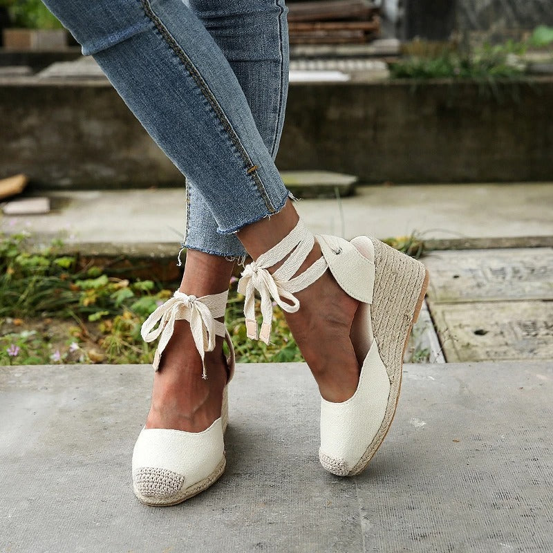 Elowen women's cream lace-up wedge espadrille sandals with closed toe and ankle ties.