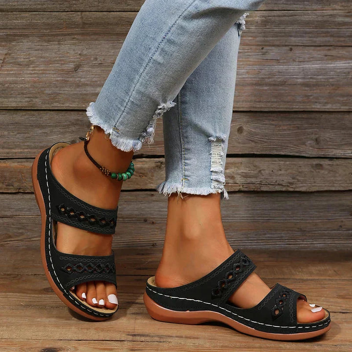 Ezra black open-toe slip-on wedge sandals with cutout strap detail, perfect for effortless warm-weather styling.