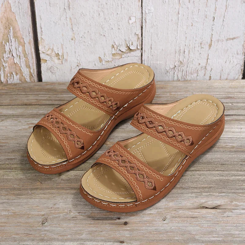 Brown Ezra women's open-toe slip-on wedge sandals with cutout strap detailing and a low wedge sole.