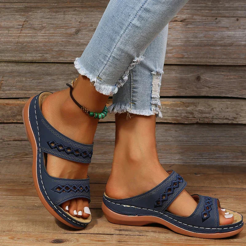 Women's Ezra navy open-toe slip-on wedge sandals with cutout straps and comfortable sole.