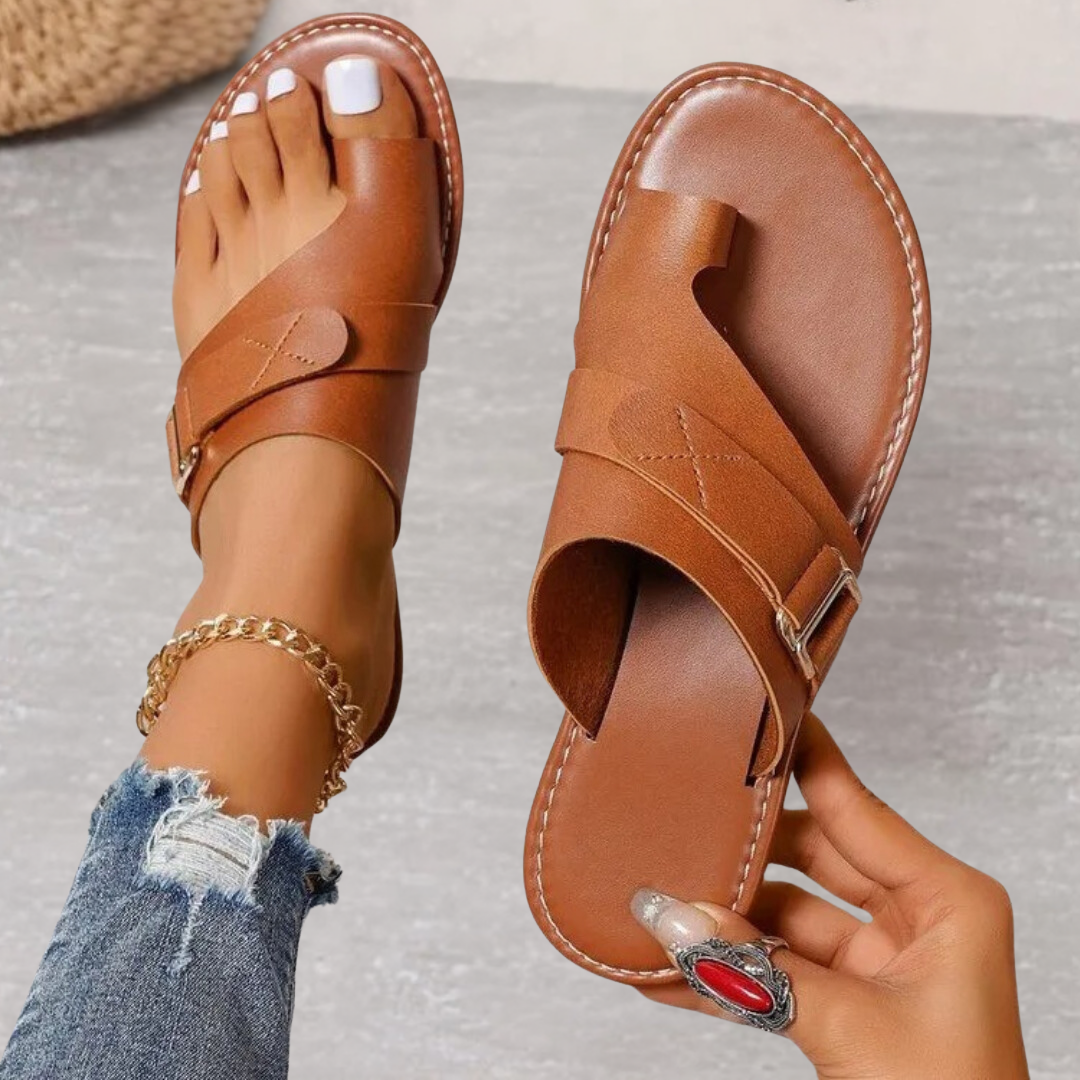 Jessamine women's brown toe loop slide sandals with wide crossover straps, buckle detail, and flat sole.
