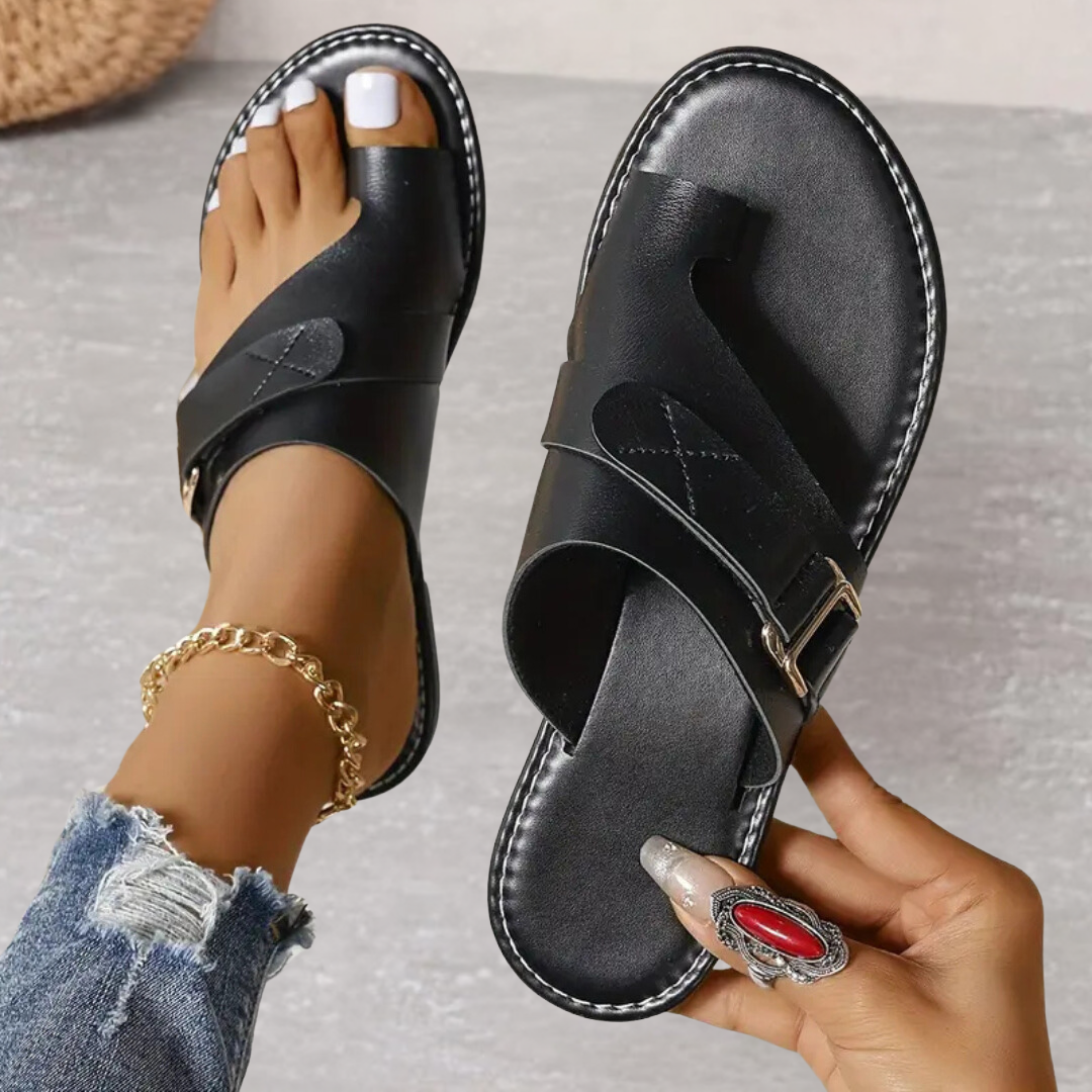 Black Jessamine women's toe loop slide sandals with wide crossover strap, buckle detail, and flat sole.