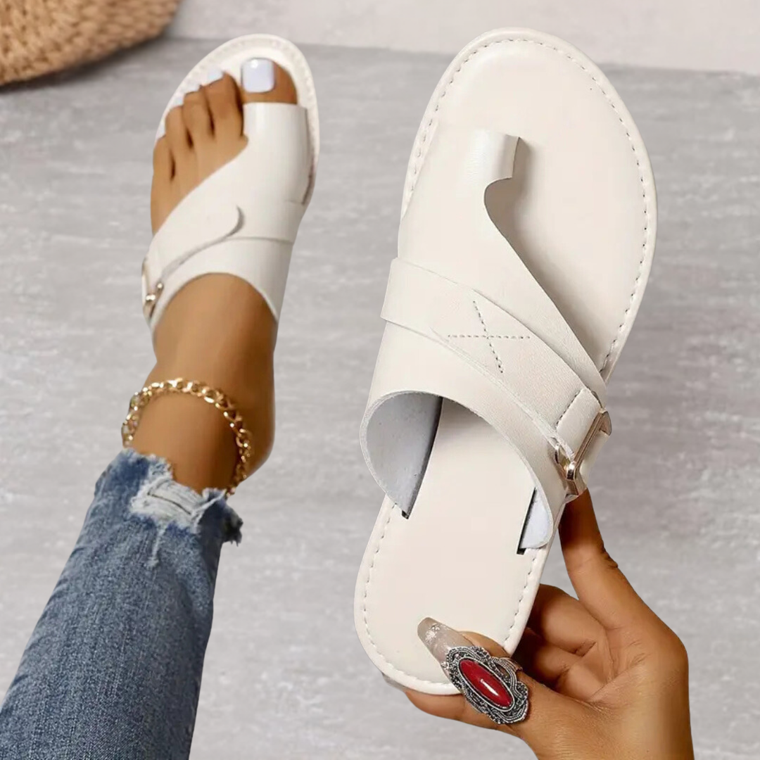 White Jessamine women's toe loop slide sandals with wide crossover strap, buckle detail, and flat sole.