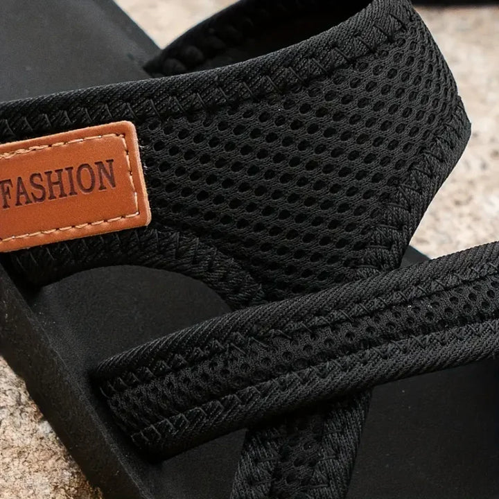 Black Kathleen women's mesh slide sandals with wide, airy straps and a brown "FASHION" tag.