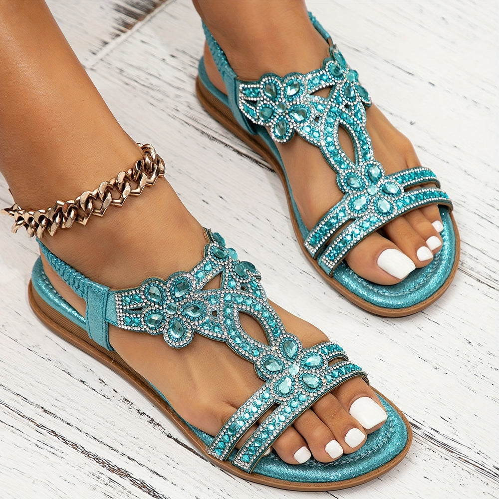 Marcella women's turquoise beaded T-strap sandals with a glossy metallic finish and sparkling embellishments.