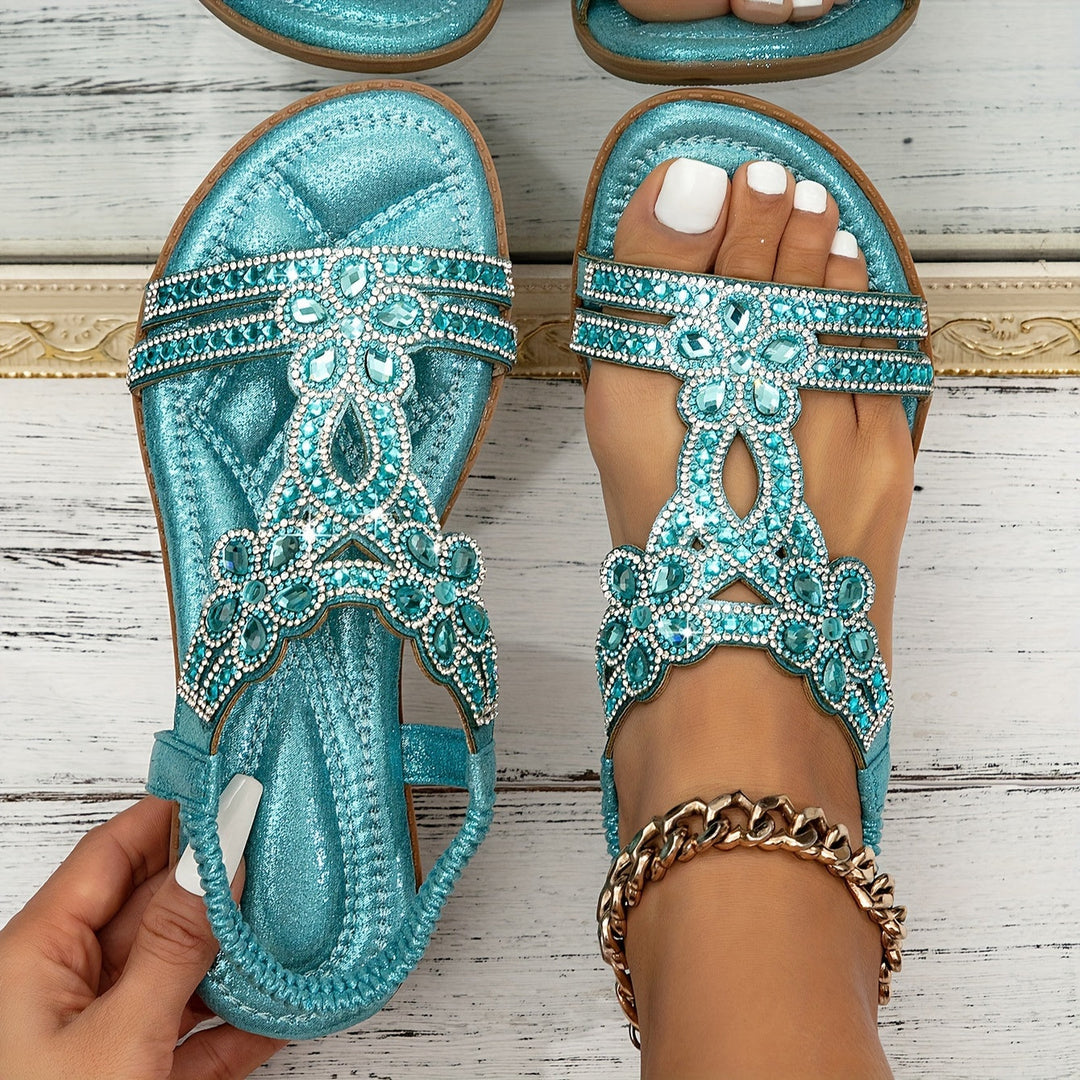 Marcella women's beaded T-strap sandals in glossy metallic turquoise, featuring sparkling embellishments.