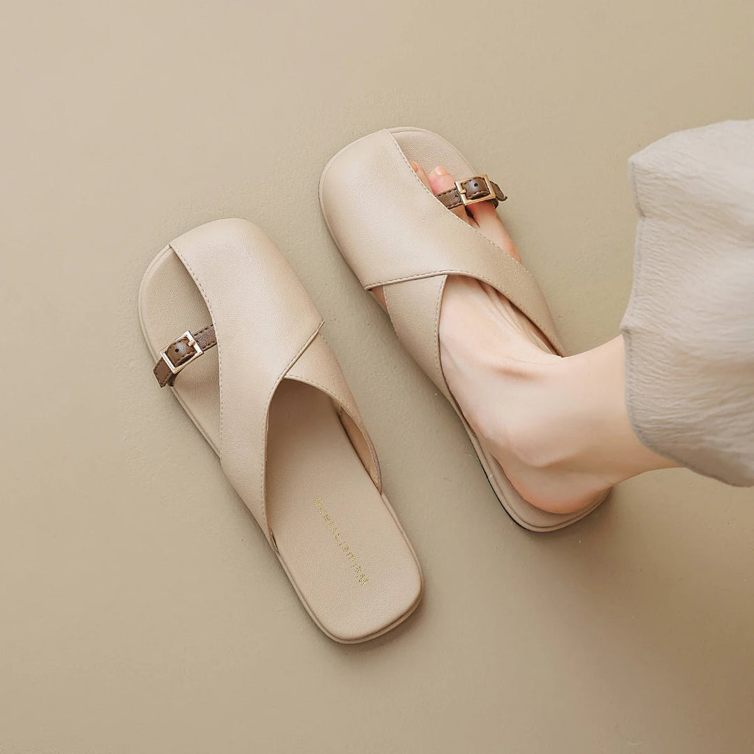 Marzella women's beige cross strap slide sandals with slim buckle detail, offering clean, polished everyday style.