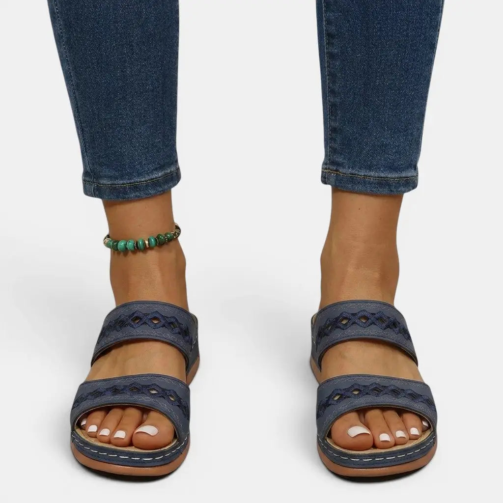 Mia women's navy double strap orthopedic slide sandals with cutout detailing and cushioned sole.