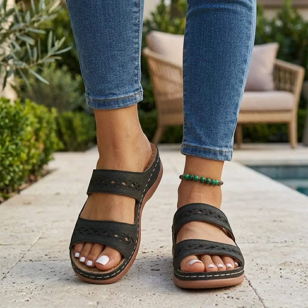 Mia black double strap orthopedic slide sandals with cutout detailing and cushioned sole.
