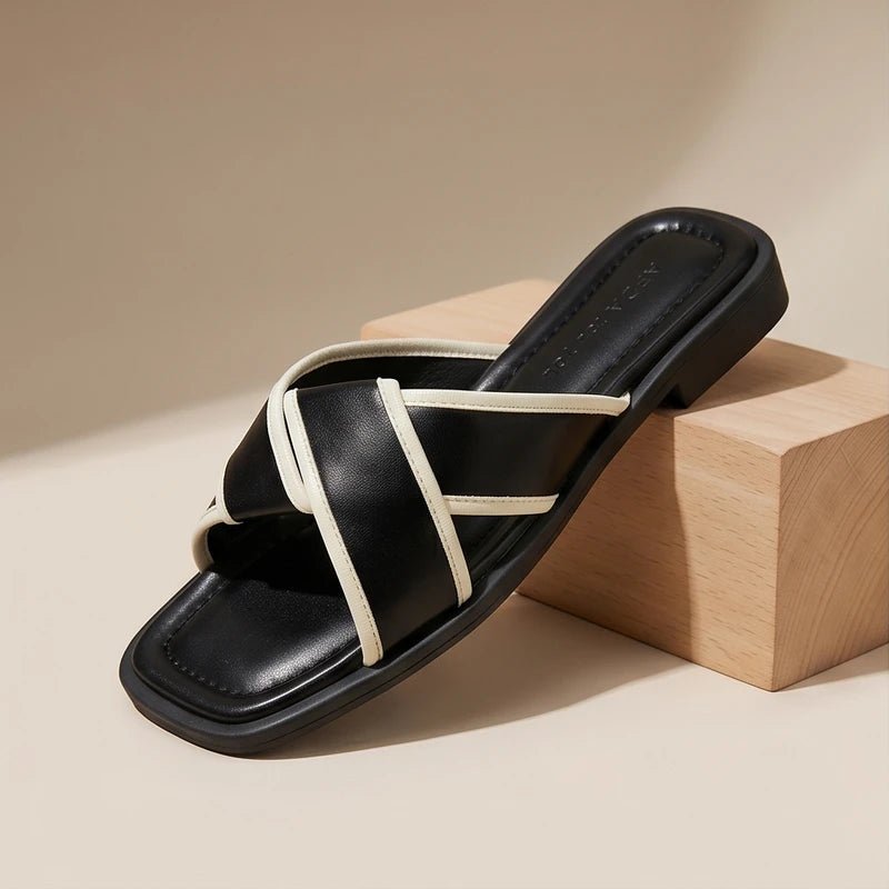 Nerissa women's black cross strap slide sandals with white contrast trim and a modern square toe.