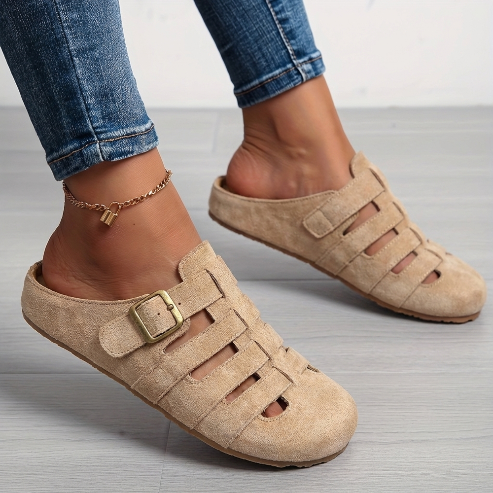 Nora women's buckle strap slip-on mule sandals in a natural beige suede finish with cutout detailing.