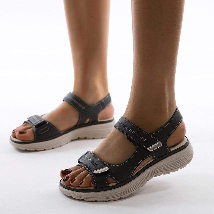 Orlena women's adjustable dark gray wedge sandals with contrast stitching and open toe design.