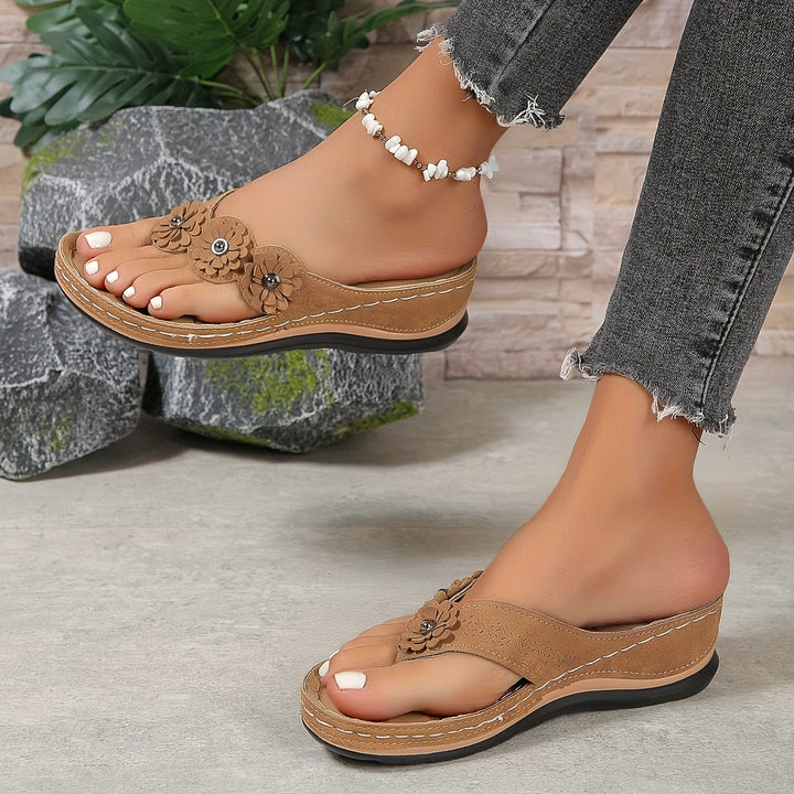 Pippa women's tan floral slide sandals with layered flower details, contrast stitching, and a low sole.