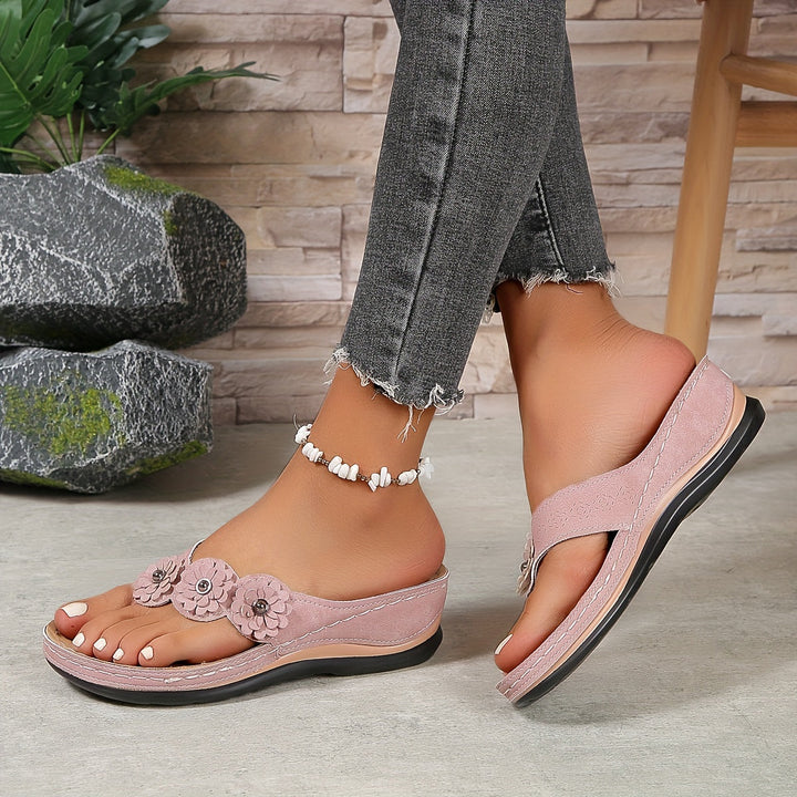 Women's Pippa pink floral slide sandals with layered flower details, contrast stitching, and a low everyday sole.