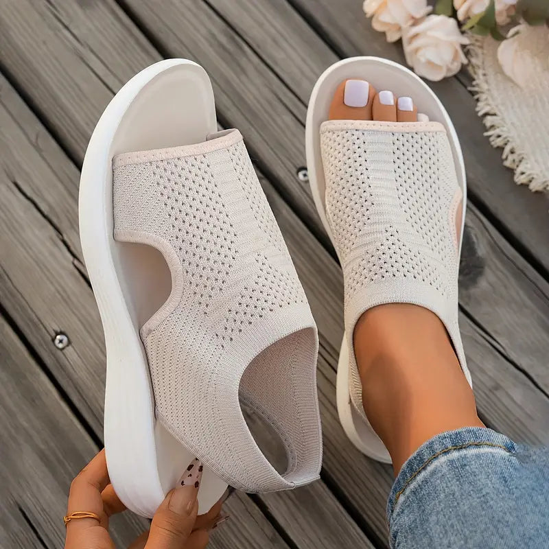 Soleil women's knit slip-on sandals in light beige with an open toe, side cutouts, and a cushioned white sole.