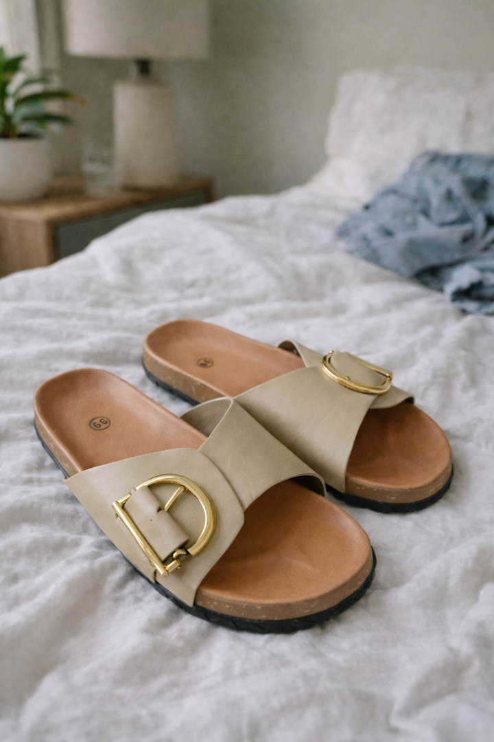 Sylvie women's buckle slide sandals in a neutral beige with a wide strap, open toe, and gold-tone buckle.