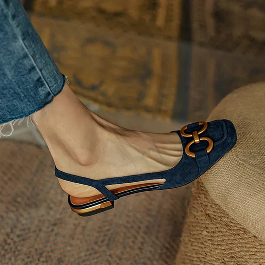 Verena women's navy suede slingback buckle flats with a closed toe, low heel, and gold-tone buckle.