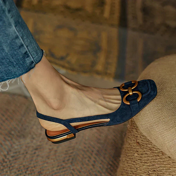 Verena women's navy suede slingback buckle flats with a closed toe, low heel, and gold-tone buckle.