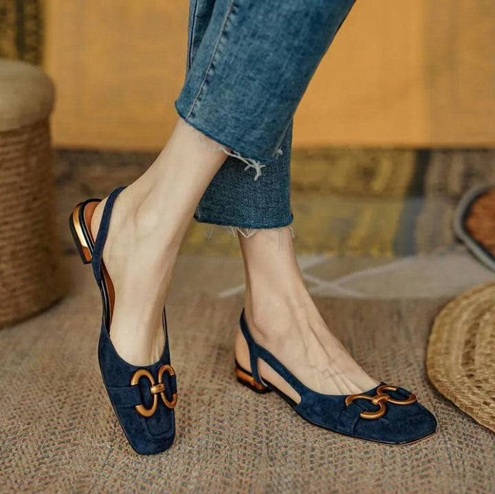 Verena women's navy slingback buckle flats with a closed toe, low flat heel, and gold-tone buckle detail.