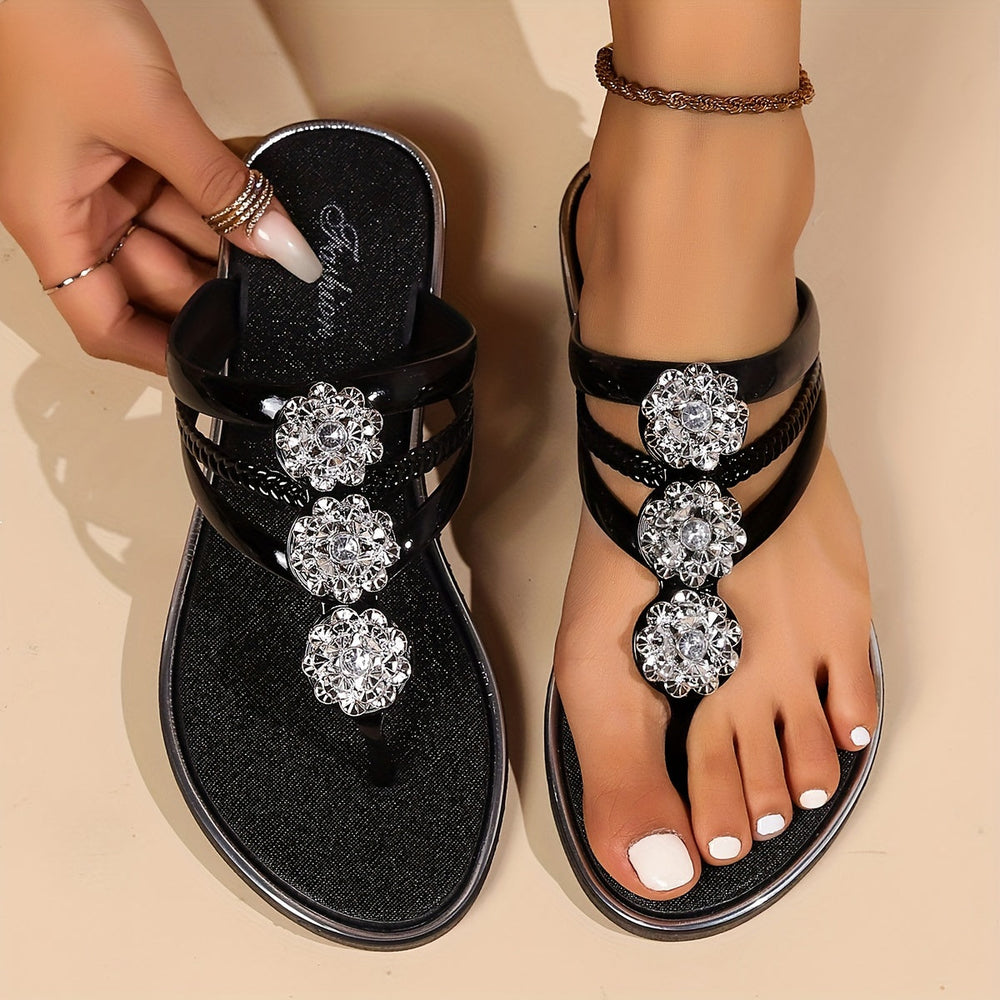 Vespera Women's black rhinestone thong sandals with metallic finish and sparkling floral accents.