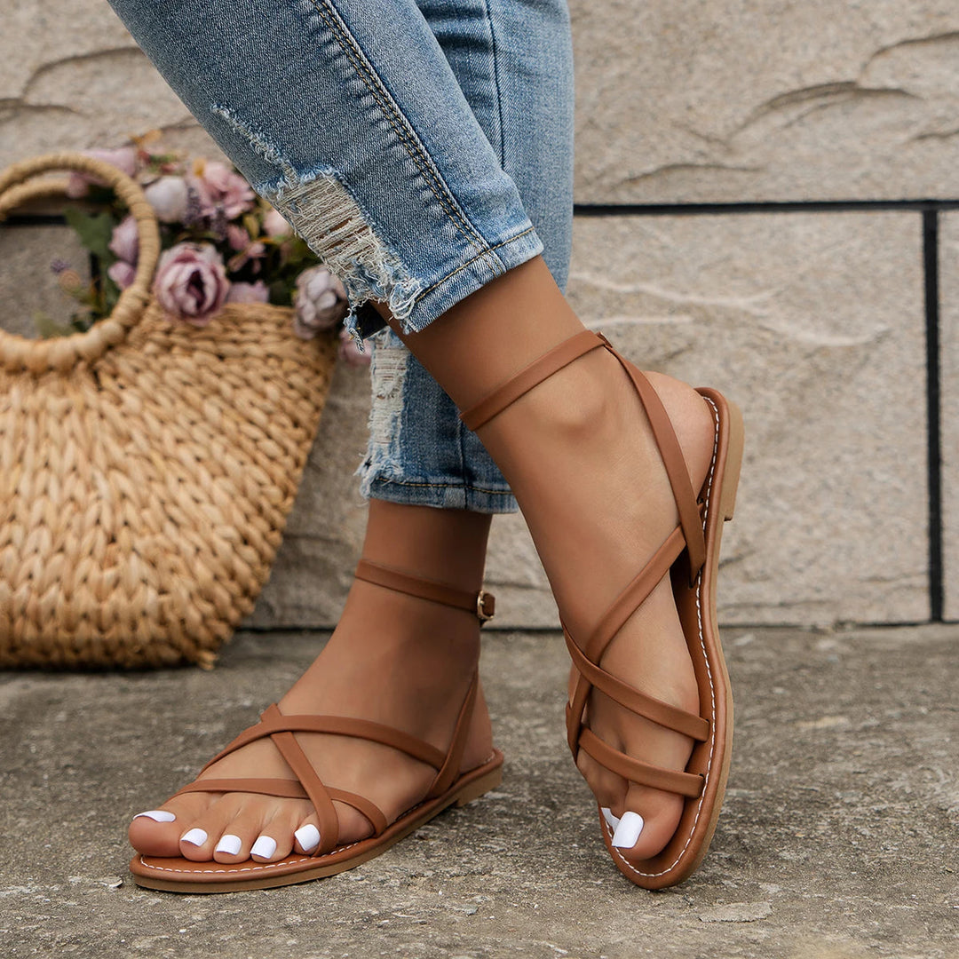 Zayra women's brown ankle strap flat sandals with slim crisscross straps, perfect for effortless summer style.