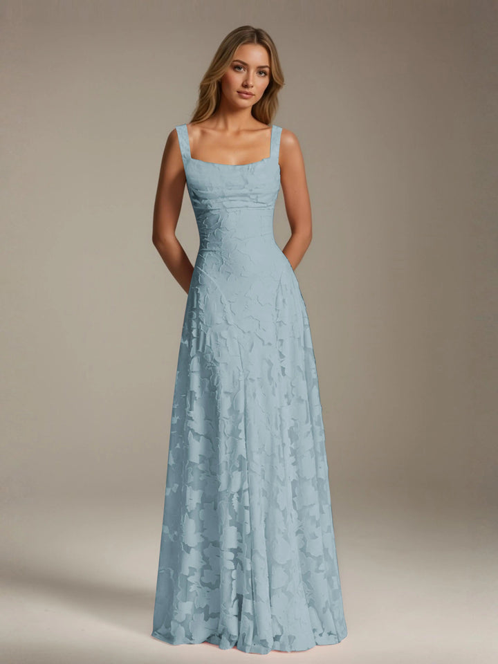 Adrienne light blue floral lace A-line bridesmaid gown with square neckline and flowing skirt.