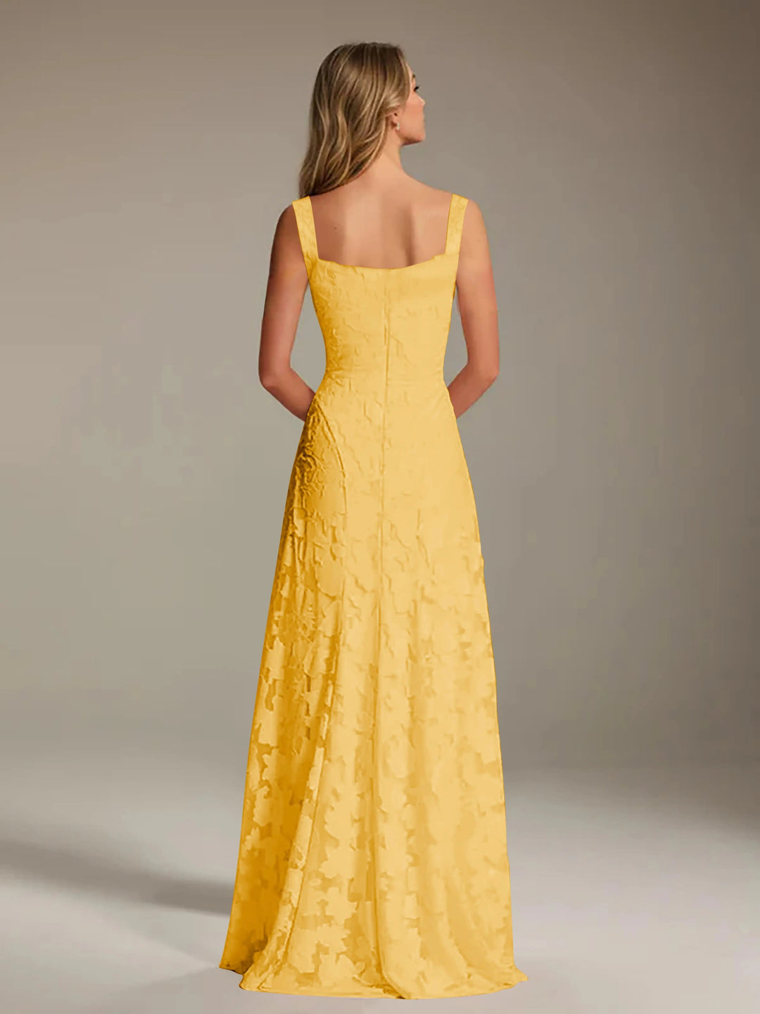 Adrienne yellow floral lace A-line bridesmaid gown with square neckline, seen from the back.