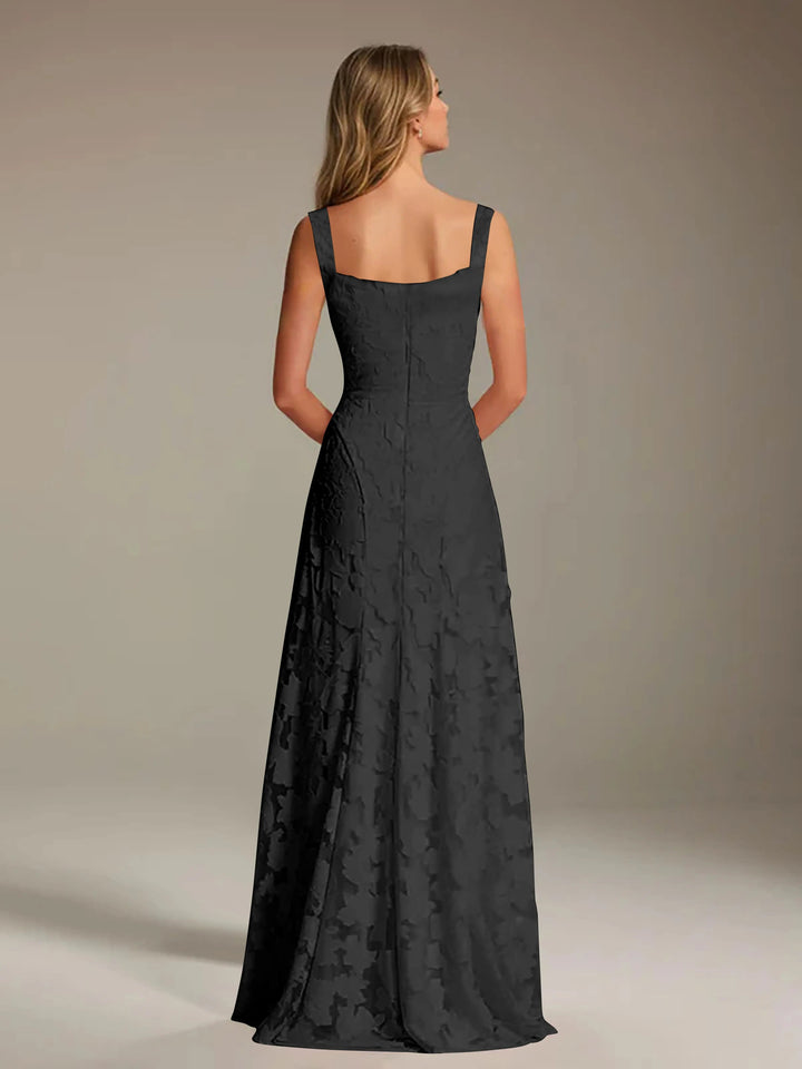 Adrienne black floral lace A-line bridesmaid gown with square neckline, viewed from the back.