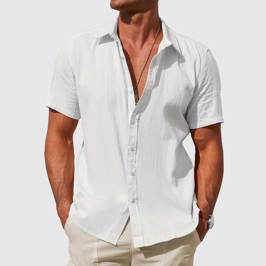 Men's Asher white short sleeve linen button-up shirt with subtle textured stripes, worn with beige pants.