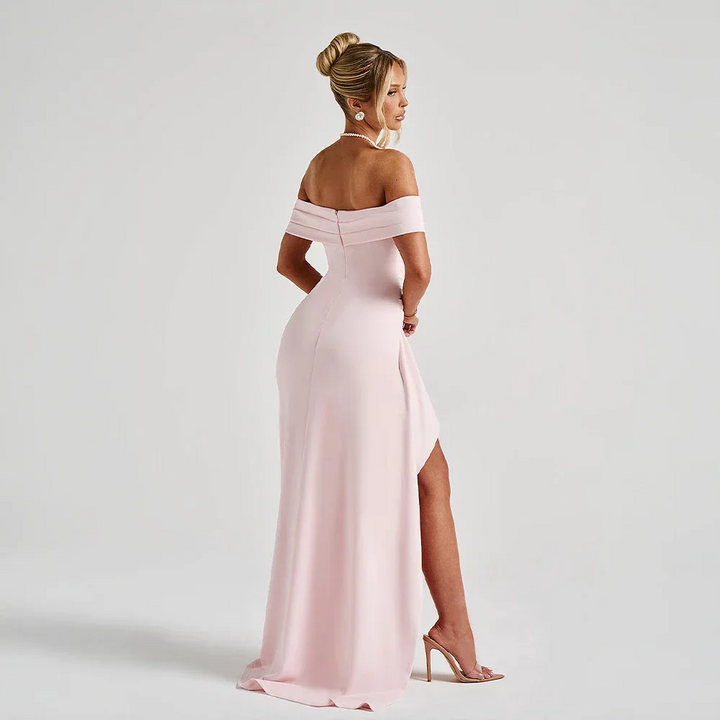 Red off-shoulder maxi dress with a high slit, flowing fabric, and elegant design.
