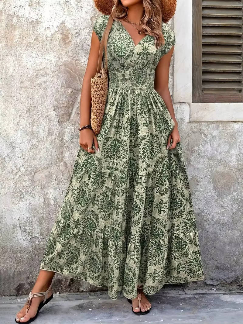 Women's green ornate print V-neck maxi boho dress with flutter sleeves and tiered skirt.