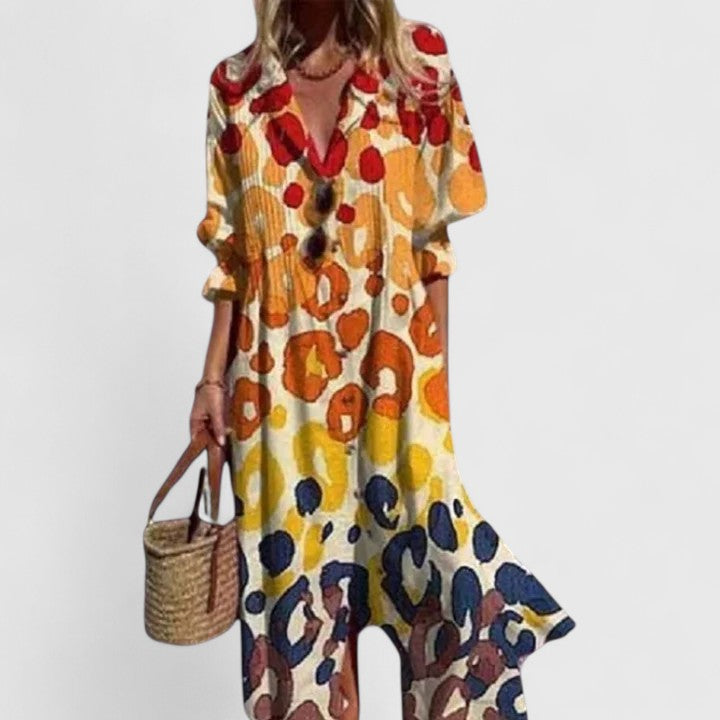 Plus size Celestine boho summer dress with bold artistic print, button-front, long sleeves, and flowing silhouette.