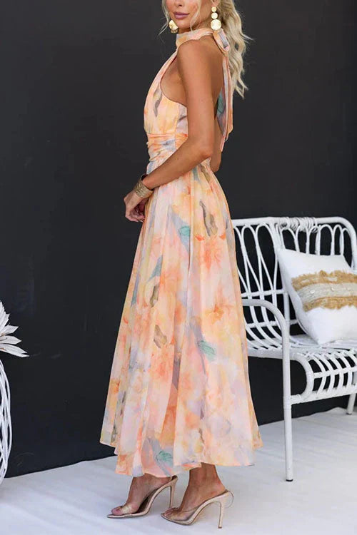 Women's Cha floral halter maxi dress in soft peach with a flowing skirt and defined waist.