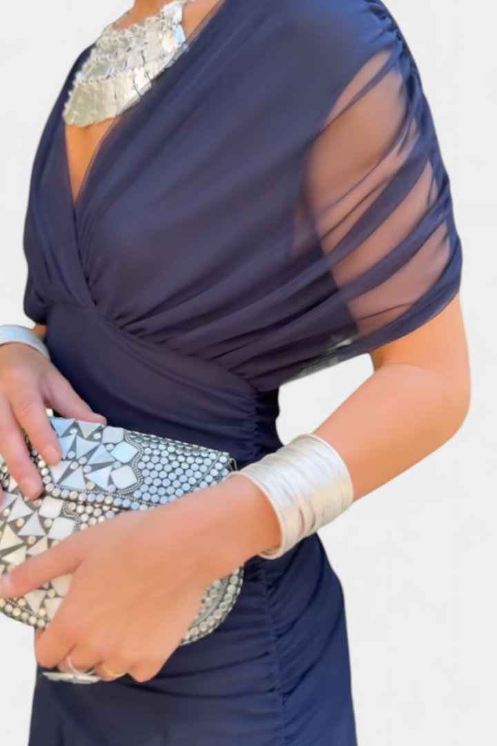 Blue floral off-shoulder maxi dress with a ruched waist, flowing skirt, and short sleeves.
