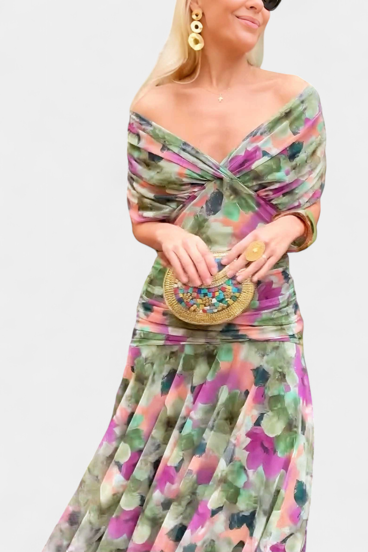 Women's floral off-shoulder maxi dress with ruched waist, flowing skirt, and vibrant print.