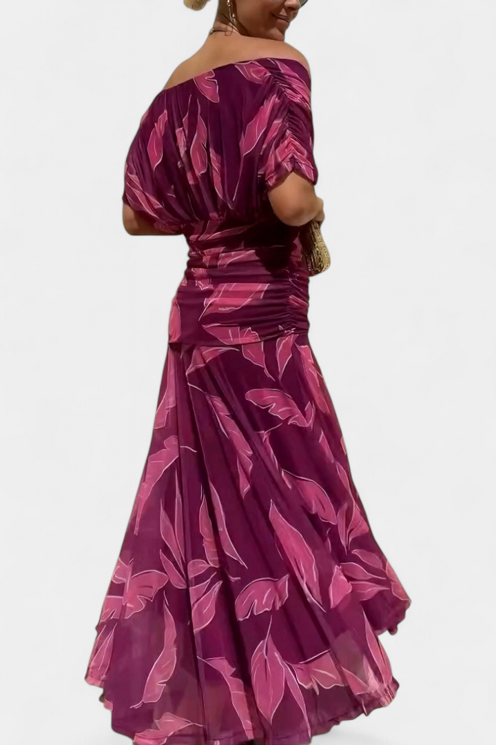 Women's floral off-shoulder maxi dress with a ruched waist, flowing skirt, and vibrant print.
