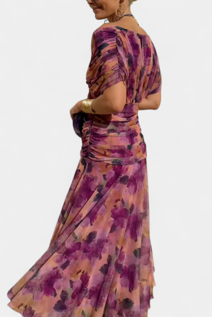 Women's floral off-shoulder maxi dress with a ruched waist, flowing skirt, and vibrant print.
