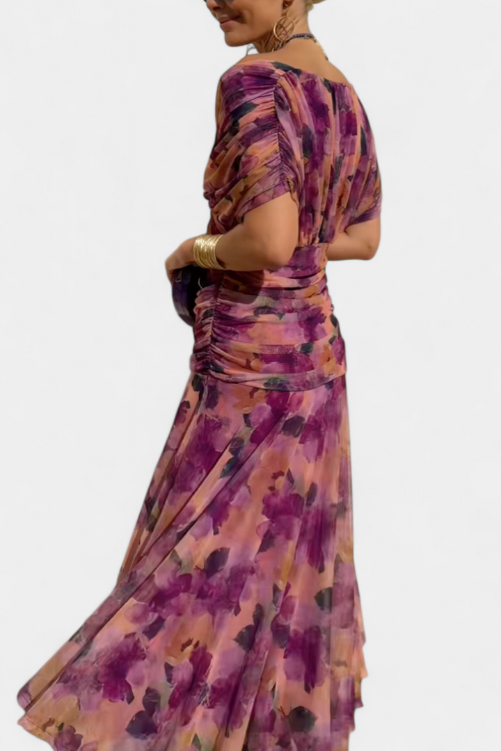 Women's floral off-shoulder maxi dress with a ruched waist, flowing skirt, and vibrant print.