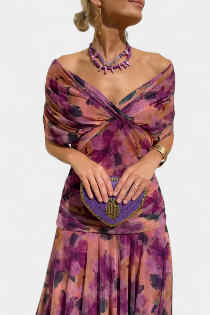 Women's floral off-shoulder maxi dress with a ruched waist, flowing skirt, and vibrant print.